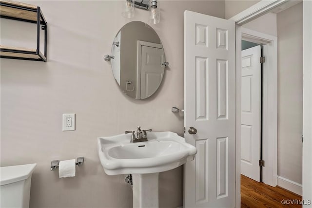 4719 W Grace St, Richmond, VA 23230 - half bathroom featuring toilet, wood finished floors, and baseboards
