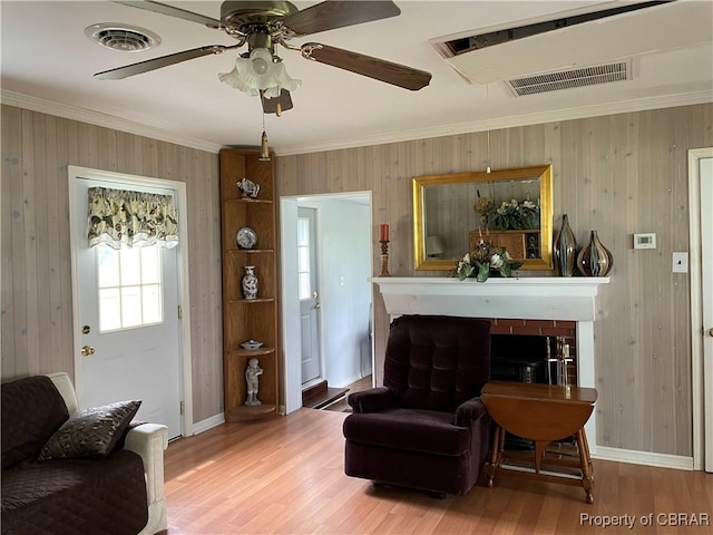 175 Riverview Ave, Water View, VA 23180 - living room with light wood finished floors, crown molding, a fireplace, a ceiling fan, and baseboards