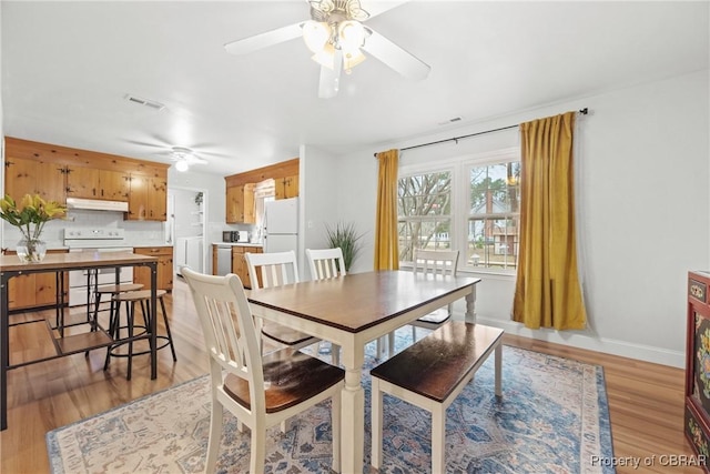 3438 Vaughan Creek Dr, Hayes, VA 23072 - dining area with a ceiling fan, light wood-type flooring, and baseboards