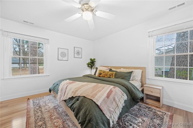 3438 Vaughan Creek Dr, Hayes, VA 23072 - bedroom featuring multiple windows, baseboards, and wood finished floors