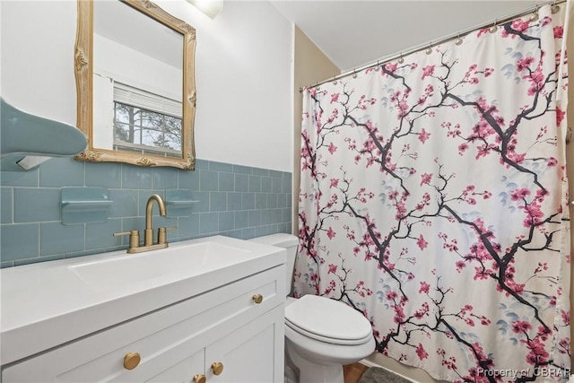 3438 Vaughan Creek Dr, Hayes, VA 23072 - full bath featuring toilet, vanity, a shower with shower curtain, a wainscoted wall, and tile walls