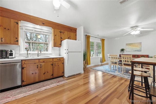 3438 Vaughan Creek Dr, Hayes, VA 23072 - kitchen with stainless steel dishwasher, freestanding refrigerator, ceiling fan, a sink, and light countertops