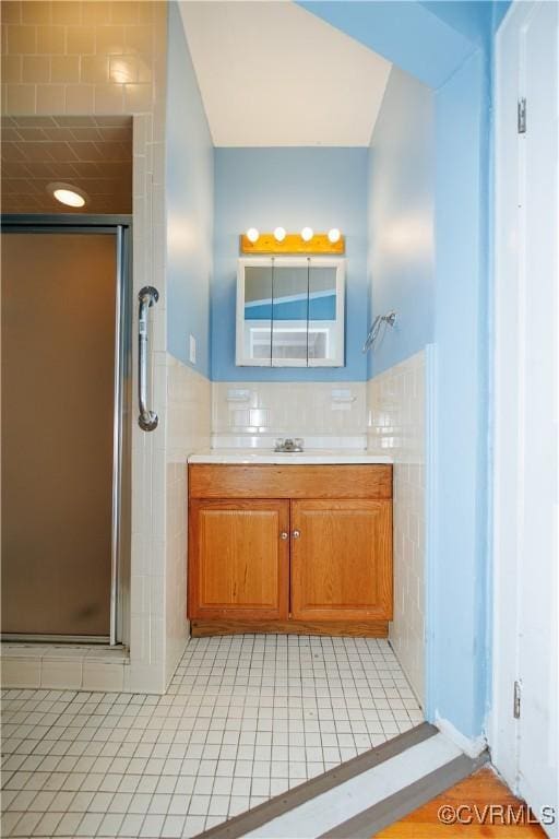 400 Allen Ave, Hopewell, VA 23860 - bathroom featuring a stall shower, vanity, tile patterned flooring, and tile walls