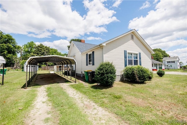 400 Allen Ave, Hopewell, VA 23860 - view of home's exterior featuring driveway, a detached carport, a lawn, and a chimney