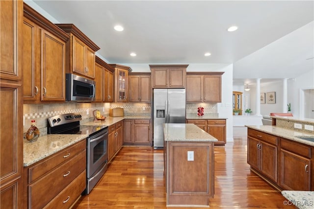 14109 Rigney Dr, Midlothian, VA 23113 - kitchen featuring stainless steel appliances, brown cabinets, decorative columns, and recessed lighting