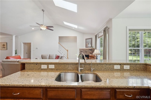 14109 Rigney Dr, Midlothian, VA 23113 - kitchen featuring open floor plan, a sink, light stone countertops, vaulted ceiling, and plenty of natural light