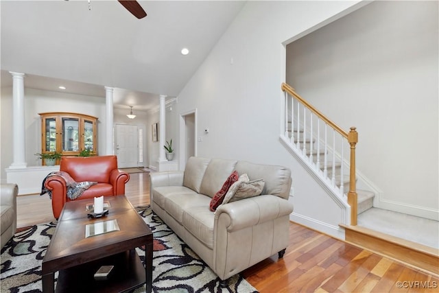 14109 Rigney Dr, Midlothian, VA 23113 - living room with decorative columns, light wood-type flooring, ceiling fan, stairs, and baseboards