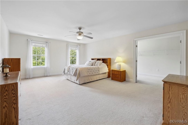 14109 Rigney Dr, Midlothian, VA 23113 - bedroom featuring light carpet, baseboards, ceiling fan, and a walk in closet