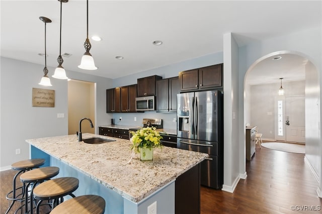 13524 Thomaswoods Ln, Ashland, VA 23005 - kitchen with appliances with stainless steel finishes, a sink, arched walkways, dark wood-style floors, and dark brown cabinets