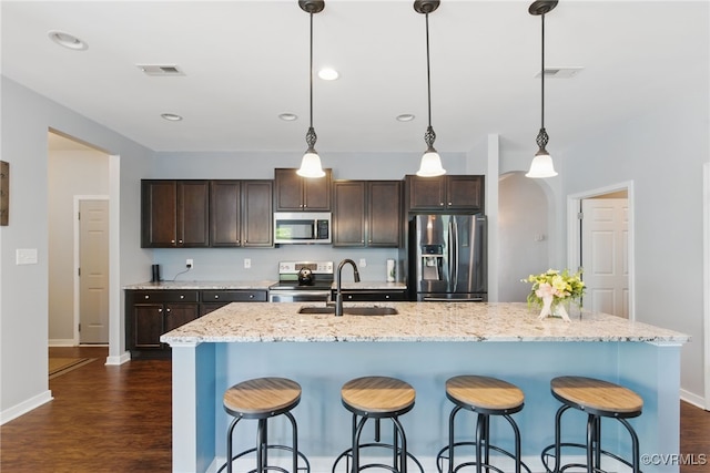 13524 Thomaswoods Ln, Ashland, VA 23005 - kitchen with stainless steel appliances, a sink, dark brown cabinetry, baseboards, and dark wood-type flooring