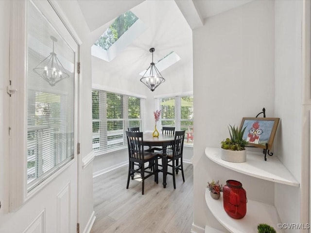 2004 Deer Meadow Ct, Chesterfield, VA 23112 - dining space featuring a chandelier, light wood-style flooring, vaulted ceiling, a skylight, and baseboards