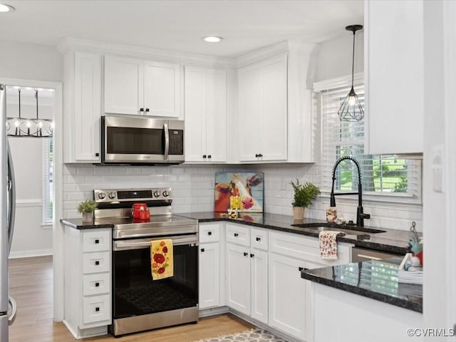 2004 Deer Meadow Ct, Chesterfield, VA 23112 - kitchen featuring appliances with stainless steel finishes, a sink, white cabinets, dark stone countertops, and light wood-style floors