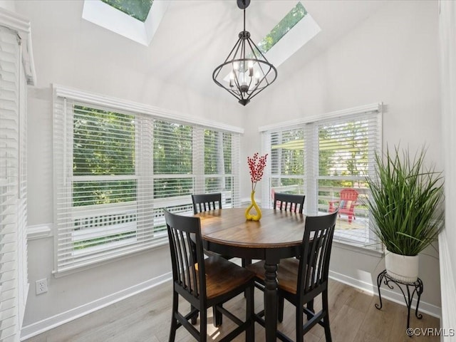 2004 Deer Meadow Ct, Chesterfield, VA 23112 - dining space featuring a skylight, a chandelier, wood finished floors, baseboards, and high vaulted ceiling
