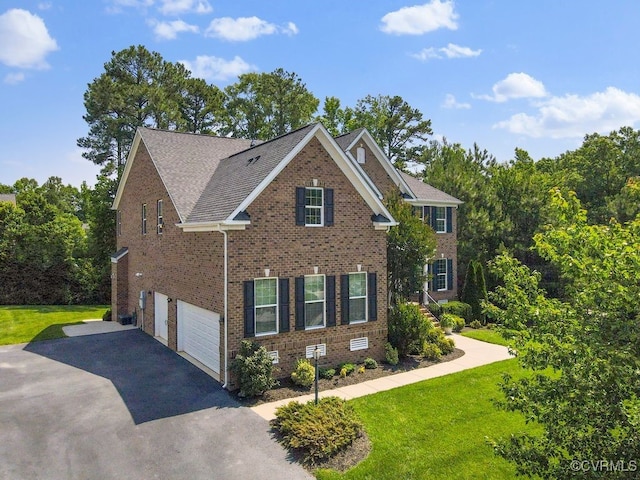 16300 Midnight Xing, Chesterfield, VA 23120 - traditional-style home with a garage, asphalt driveway, brick siding, and a front yard
