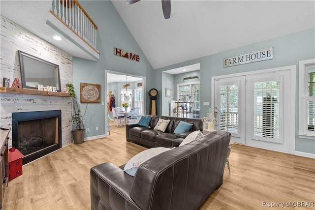 6304 Belroi Rd, Abingdon, VA 23061 - living room with high vaulted ceiling, a fireplace, wood finished floors, a ceiling fan, and plenty of natural light