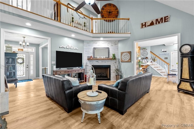 6304 Belroi Rd, Abingdon, VA 23061 - living area featuring a high ceiling, wood finished floors, a chandelier, stairway, and a fireplace