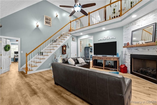 6304 Belroi Rd, Abingdon, VA 23061 - living room with a towering ceiling, stairs, a ceiling fan, wood finished floors, and a fireplace