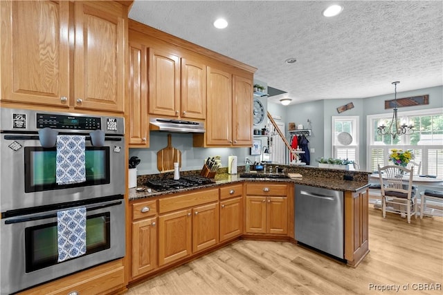 6304 Belroi Rd, Abingdon, VA 23061 - kitchen with stainless steel appliances, light wood-style floors, a textured ceiling, a sink, and dark stone countertops