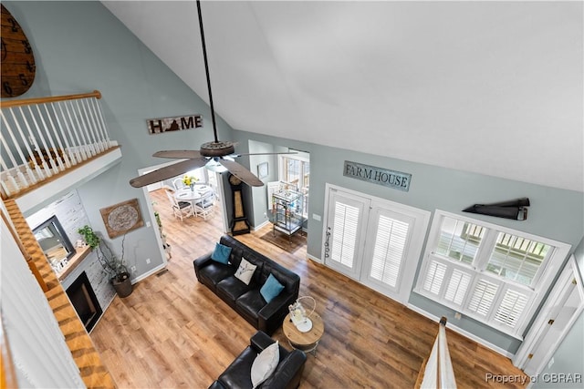 6304 Belroi Rd, Abingdon, VA 23061 - living room featuring wood finished floors, a fireplace, ceiling fan, healthy amount of natural light, and high vaulted ceiling