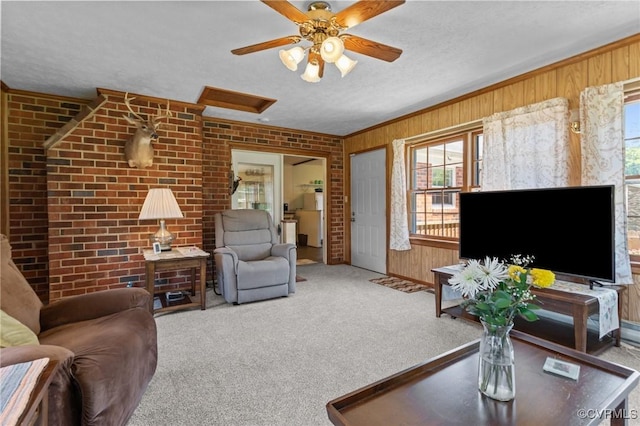2721 Fawnwick Dr, Henrico, VA 23231 - carpeted living area with healthy amount of natural light, wood walls, a ceiling fan, a textured ceiling, and brick wall
