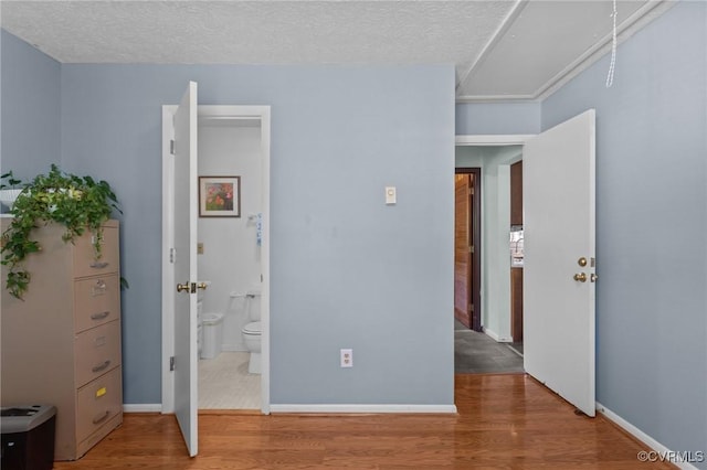 2721 Fawnwick Dr, Henrico, VA 23231 - unfurnished bedroom with wood finished floors, a textured ceiling, baseboards, and ensuite bath