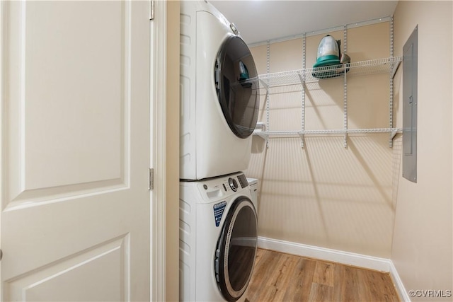 124 Vogel Rd, Cumberland, VA 23040 - laundry room featuring stacked washing machine and dryer, wood finished floors, and baseboards