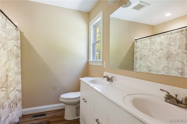 124 Vogel Rd, Cumberland, VA 23040 - bathroom featuring toilet, baseboards, wood finished floors, and double vanity