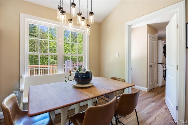 124 Vogel Rd, Cumberland, VA 23040 - dining room featuring stacked washer / dryer, light wood-style floors, baseboards, and lofted ceiling