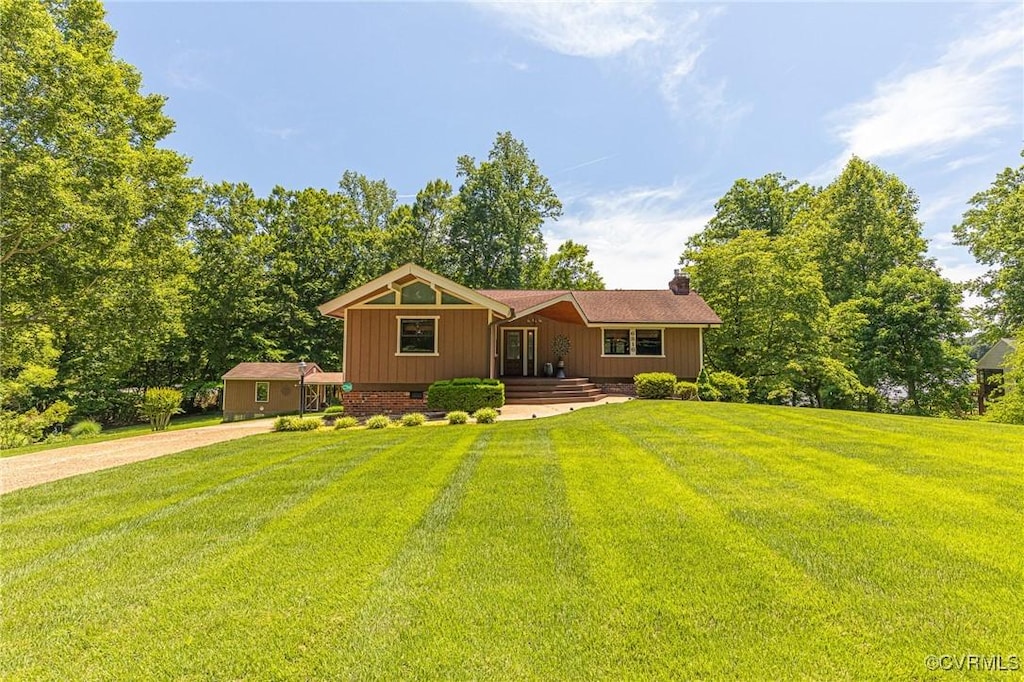 6816 Lakeshore Dr, Quinton, VA 23141 - view of front facade with a front lawn, a chimney, and driveway