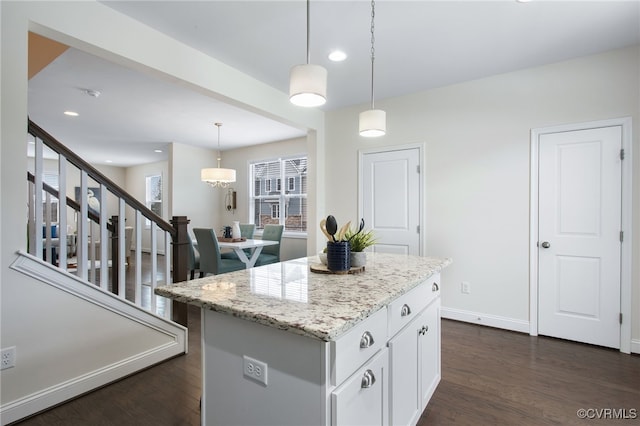 5200 Gower Pl, Glen Allen, VA 23059 - kitchen with dark wood-type flooring, light stone counters, a center island, white cabinets, and pendant lighting