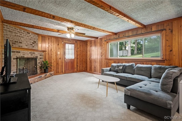 7708 Stonetree Dr, North Chesterfield, VA 23235 - living room with wood walls, ceiling fan, light colored carpet, beamed ceiling, and a brick fireplace