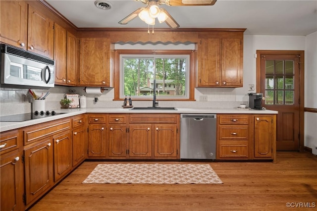 7708 Stonetree Dr, North Chesterfield, VA 23235 - kitchen featuring appliances with stainless steel finishes, a sink, and brown cabinets