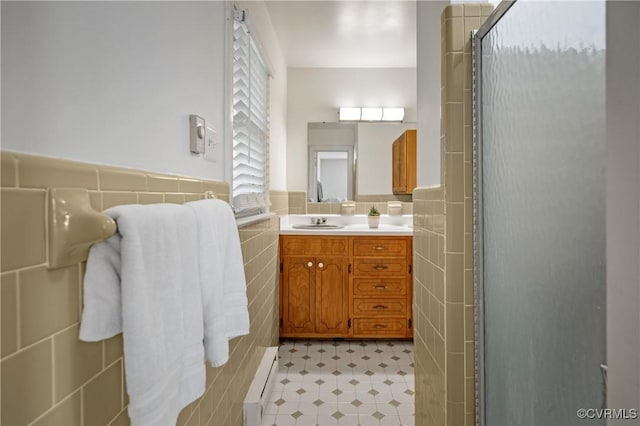 7708 Stonetree Dr, North Chesterfield, VA 23235 - bathroom with tile walls, baseboard heating, a stall shower, tile patterned floors, and vanity