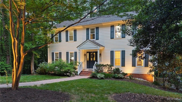 colonial house featuring a front yard