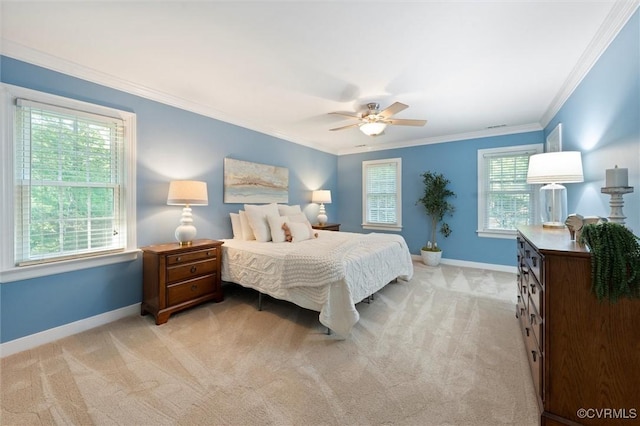 bedroom with light colored carpet, baseboards, ornamental molding, and a ceiling fan