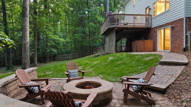 view of patio / terrace with a fire pit and a deck