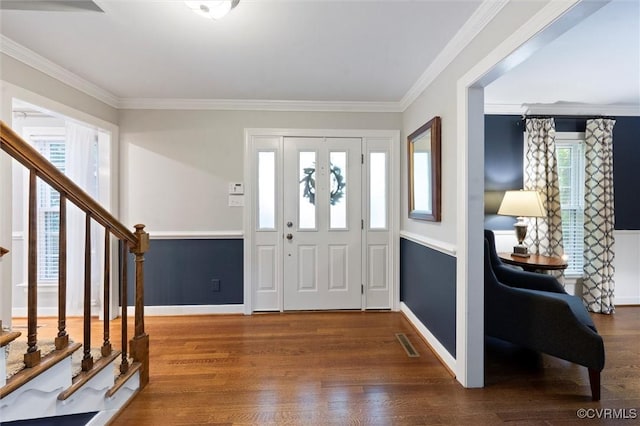 entryway featuring wood finished floors, stairway, baseboards, and ornamental molding
