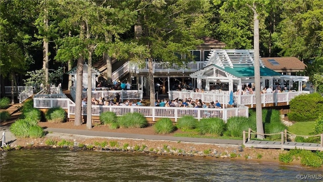 rear view of property with a deck with water view
