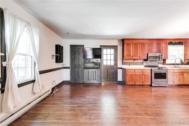12416 Mount Hermon Rd, Ashland, VA 23005 - kitchen with stainless steel appliances, light countertops, brown cabinetry, and dark wood-style floors