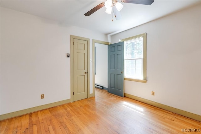 12416 Mount Hermon Rd, Ashland, VA 23005 - empty room featuring a baseboard heating unit, light wood finished floors, ceiling fan, and baseboards