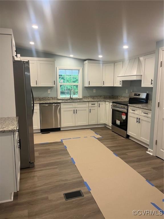 2720 Brunswick Rd, Emporia, VA 23847 - kitchen with stainless steel appliances, custom range hood, a sink, dark wood-style floors, and white cabinetry