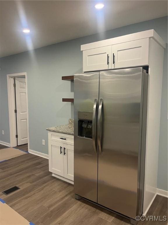 2720 Brunswick Rd, Emporia, VA 23847 - kitchen featuring stainless steel refrigerator with ice dispenser, dark wood finished floors, white cabinets, baseboards, and recessed lighting