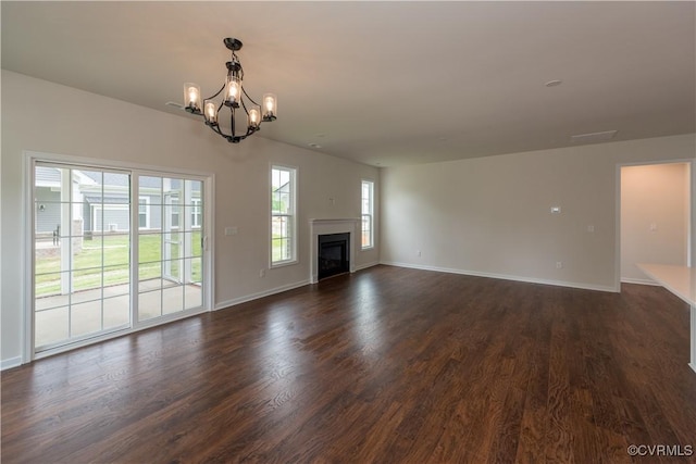 5142 Stavely Rd, Chester, VA 23831 - unfurnished living room featuring a chandelier, baseboards, dark wood-style floors, and a fireplace