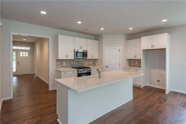 5142 Stavely Rd, Chester, VA 23831 - kitchen with stainless steel appliances, dark wood-style floors, backsplash, white cabinets, and recessed lighting