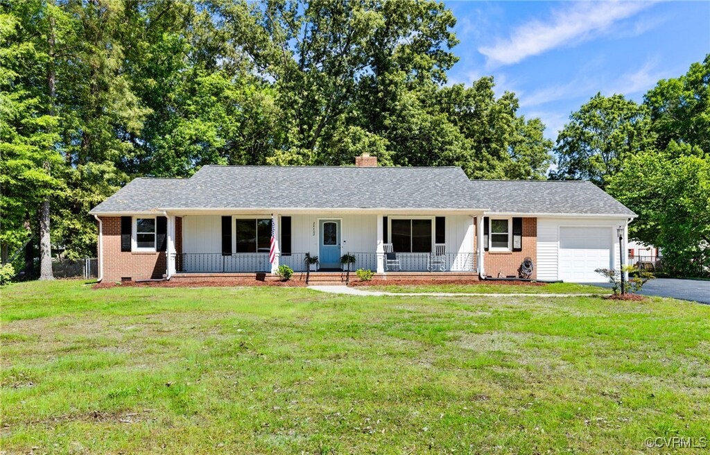 24402 Driver Rd, Dinwiddie, VA 23803 - ranch-style home with an attached garage, a porch, brick siding, and driveway