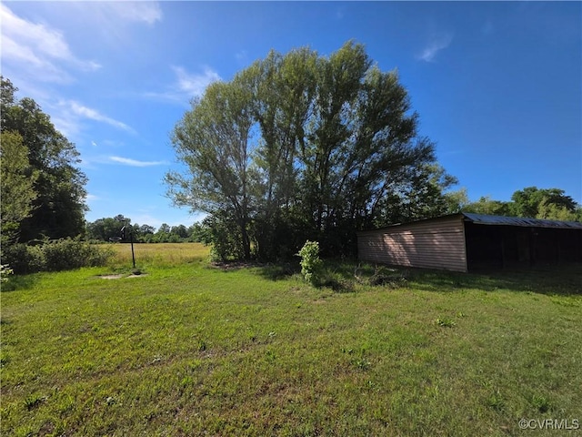 2446 Mantua Rd, Stevensville, VA 23161 - view of green lawn featuring a pole building and an outbuilding