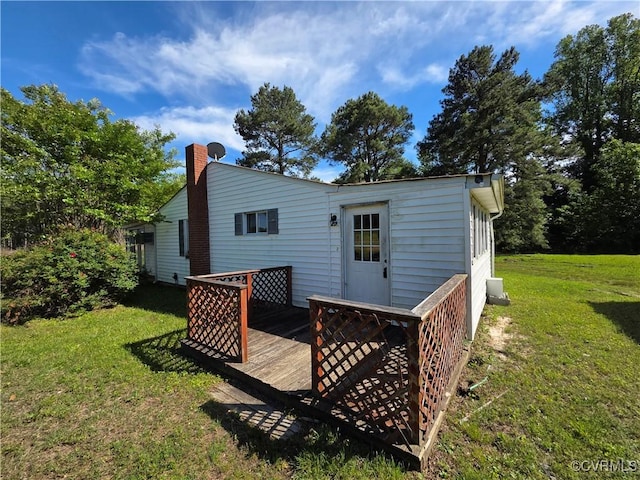 2446 Mantua Rd, Stevensville, VA 23161 - back of property featuring a deck, a chimney, and a yard