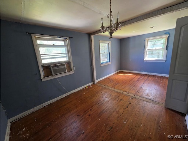 2446 Mantua Rd, Stevensville, VA 23161 - unfurnished room featuring wood-type flooring, a chandelier, baseboards, and healthy amount of natural light