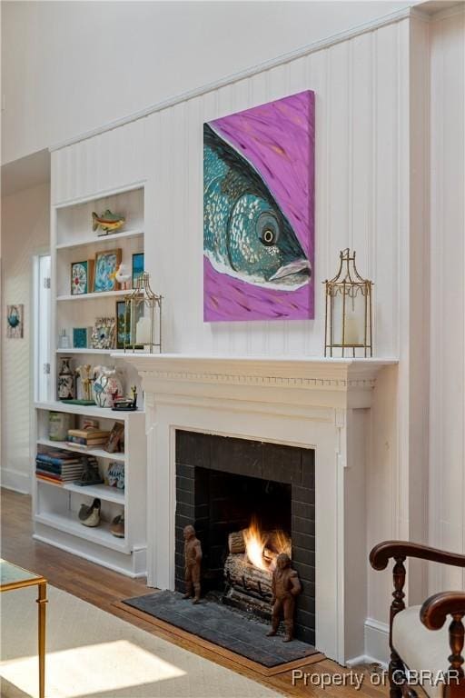 20 Winstead Dr, Irvington, VA 22480 - detailed view of a warm lit fireplace, wood finished floors, built in features, and baseboards