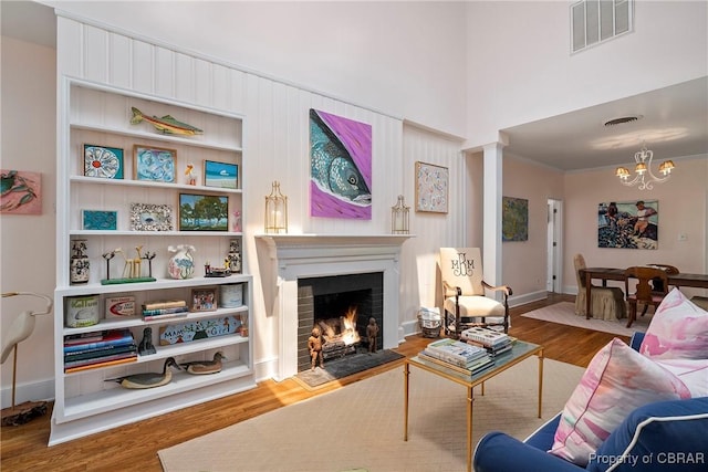 20 Winstead Dr, Irvington, VA 22480 - living room with a fireplace with flush hearth, wood finished floors, a chandelier, and baseboards